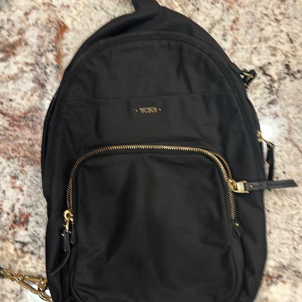 Tumi sling backpack purse.